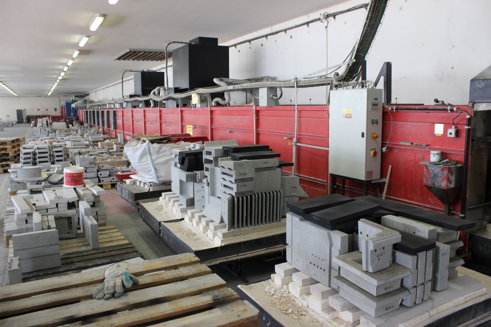 Industrial furnace line with products and handling equipment in a manufacturing plant